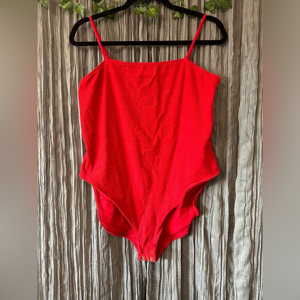 Red ribbed body suit with adjustable buttons on the bottom